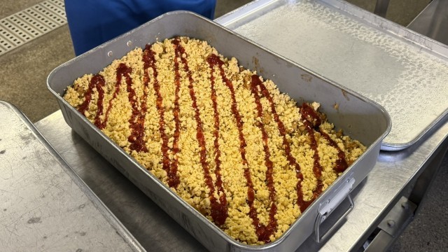 ごはんバットにチキンライスをチキンライスを入れて、炒り卵を乗せて、最後にケチャップをかけます。